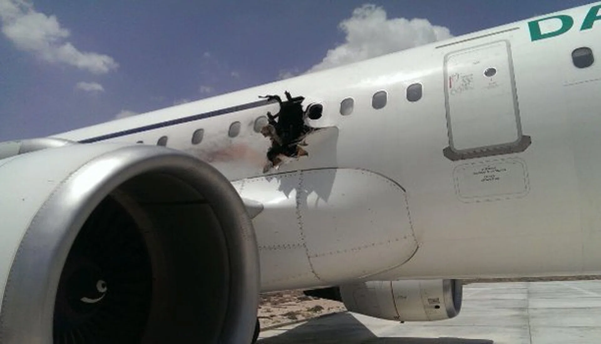 A photo depicts the hole in the fuselage of a Daallo Airlines jet after an explosion forced it to return to Somalia.