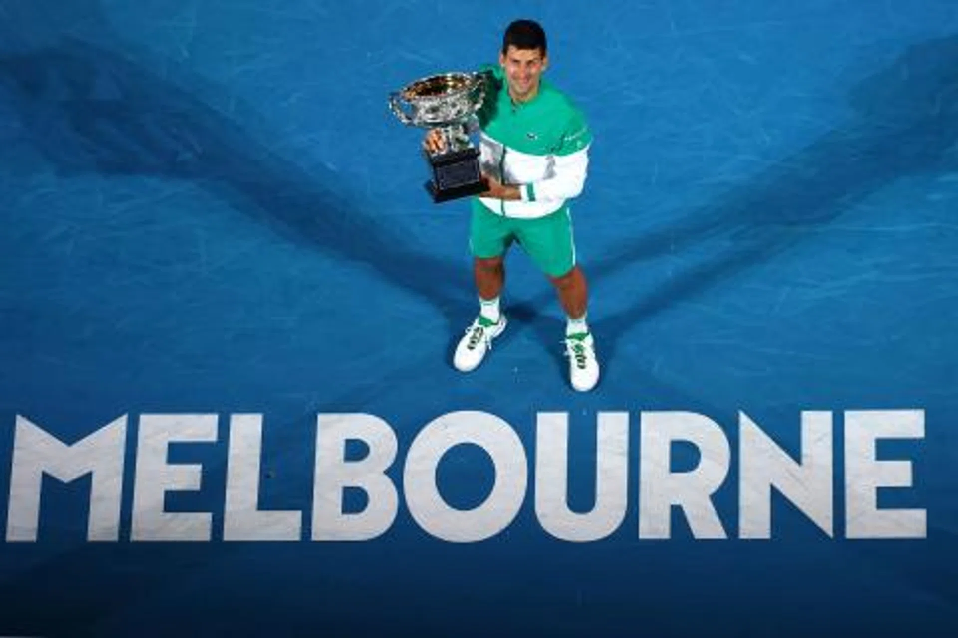 Novak Djokovic holding the Norman Brookes Challenge Cup after beating Daniil Medvedev in the 2021 Australian Open final.