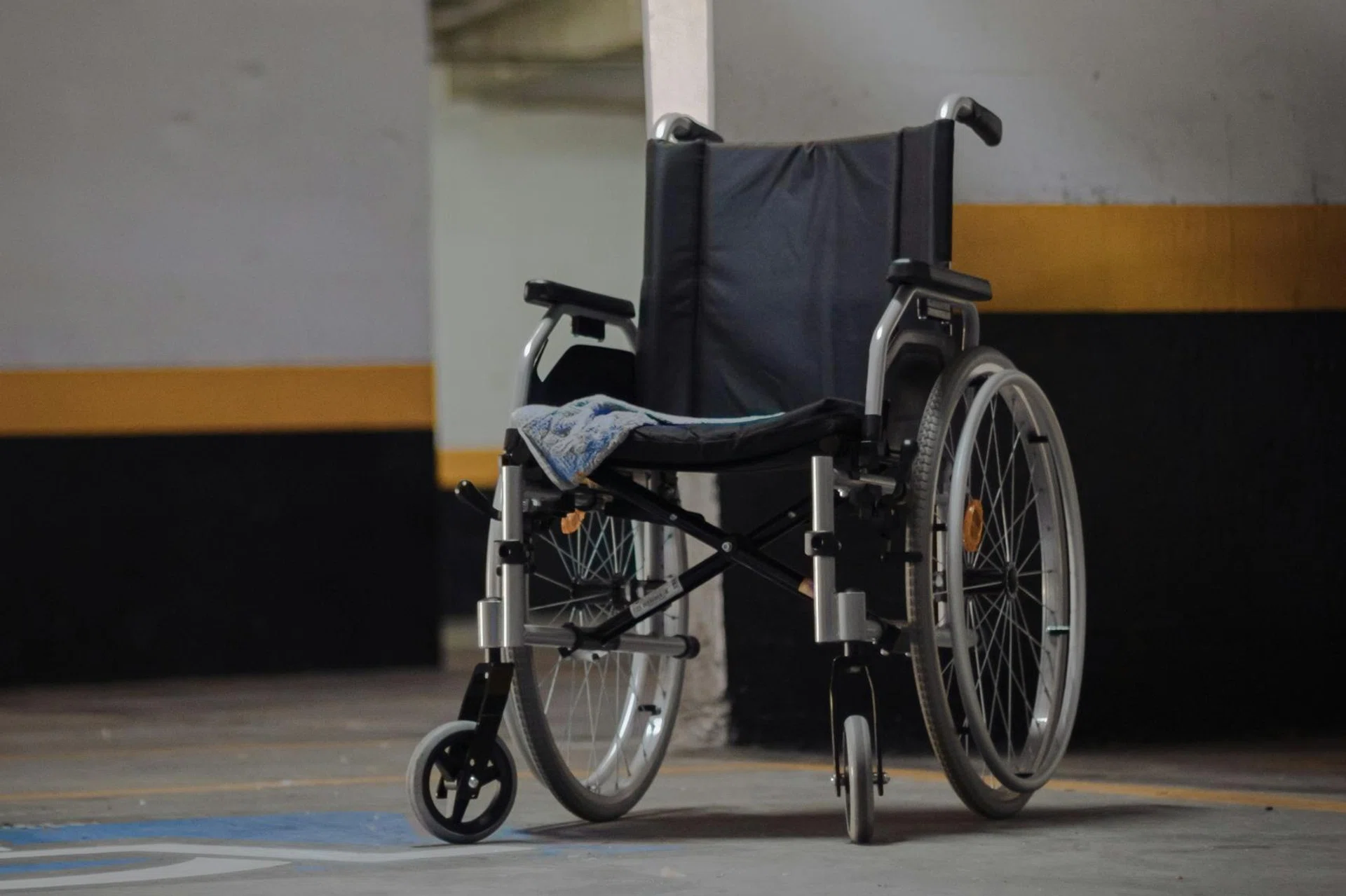 Two employees had failed to ensure that the brakes of the client's wheelchair were engaged, causing his death.