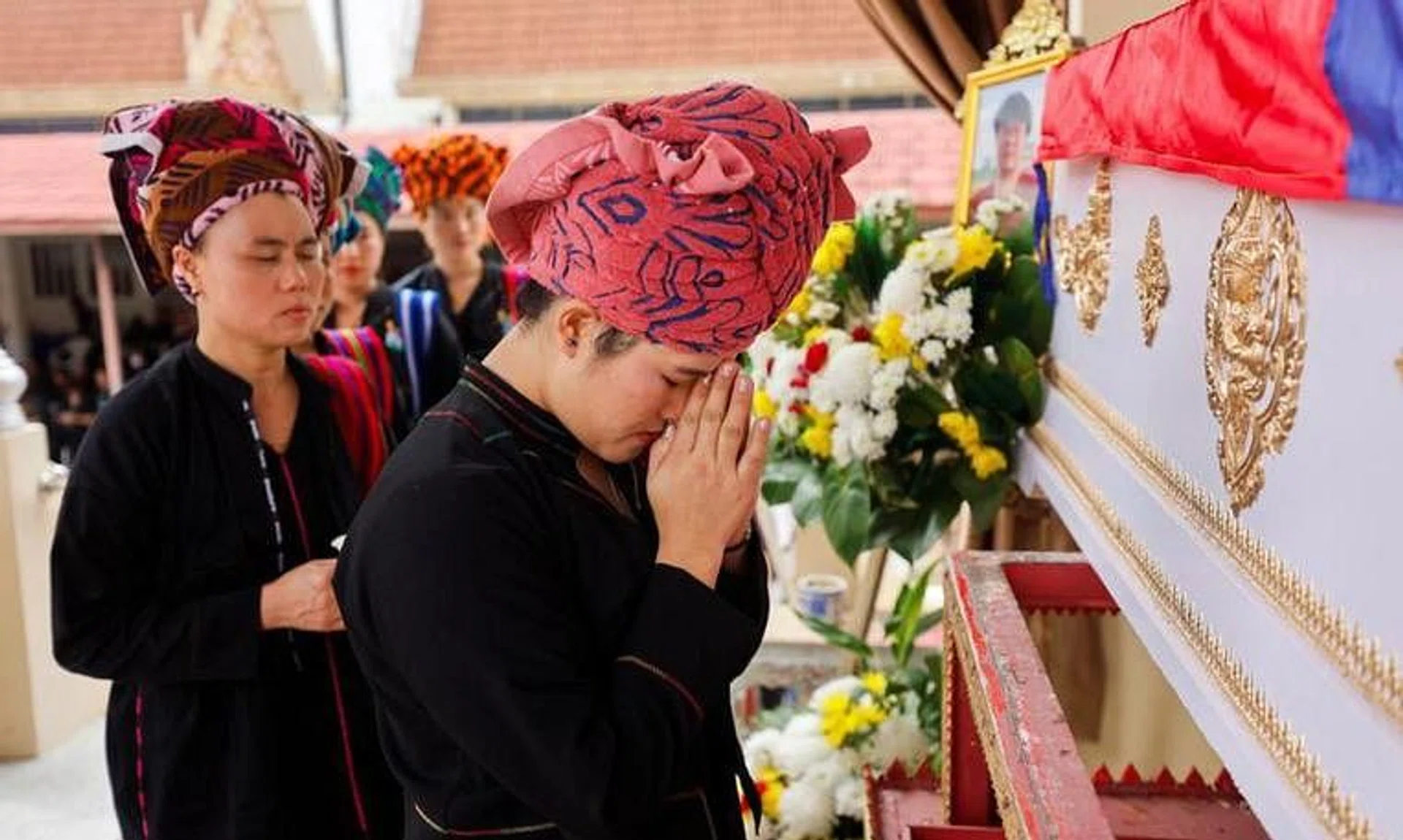 Mourners attend the cremation ceremony of Moe Myint, a 31-year-old Burmese victim of the Thailand mall shooting, at a temple in Nonthaburi, Thailand, October 8, 2023. REUTERS/Jorge Silva