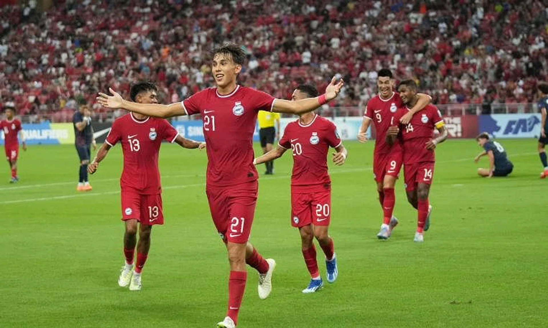 Jacob Mahler celebrates with teammates after scoring Singapore's second goal in the 2-0 win over Guam.