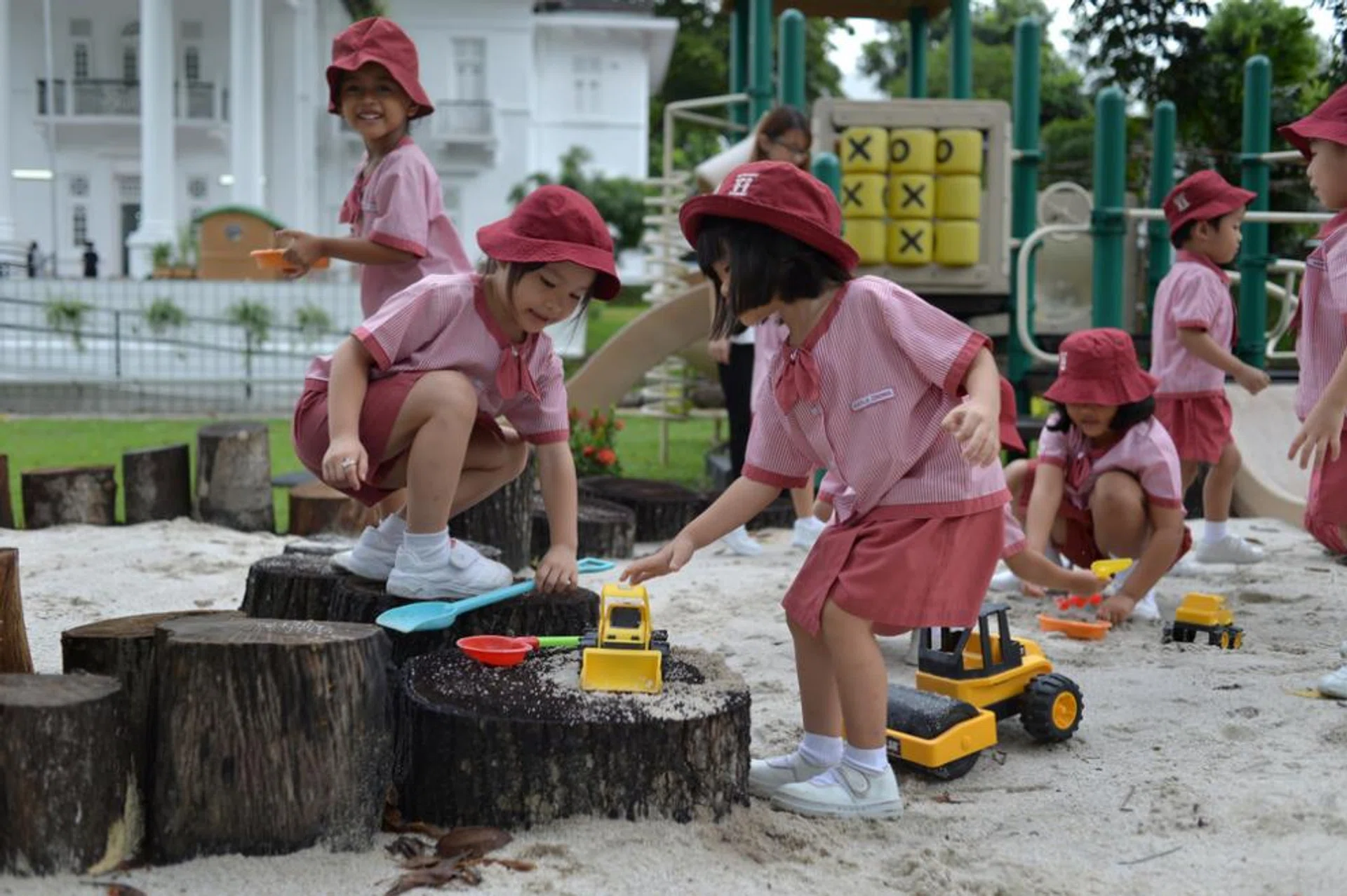 Children from a nursery class at St James’ Church Kindergarten playing outdoors at a sandpit