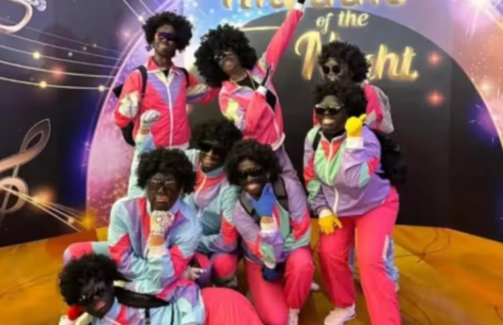 The attendees wore blackface make-up and afro wigs.