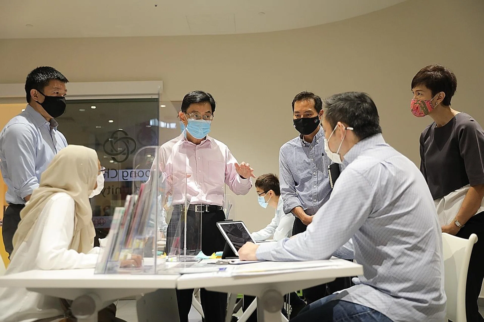 Mr Heng Swee Keat (in pink shirt) during his visit to the SGUnited Jobs and Skills Centre.