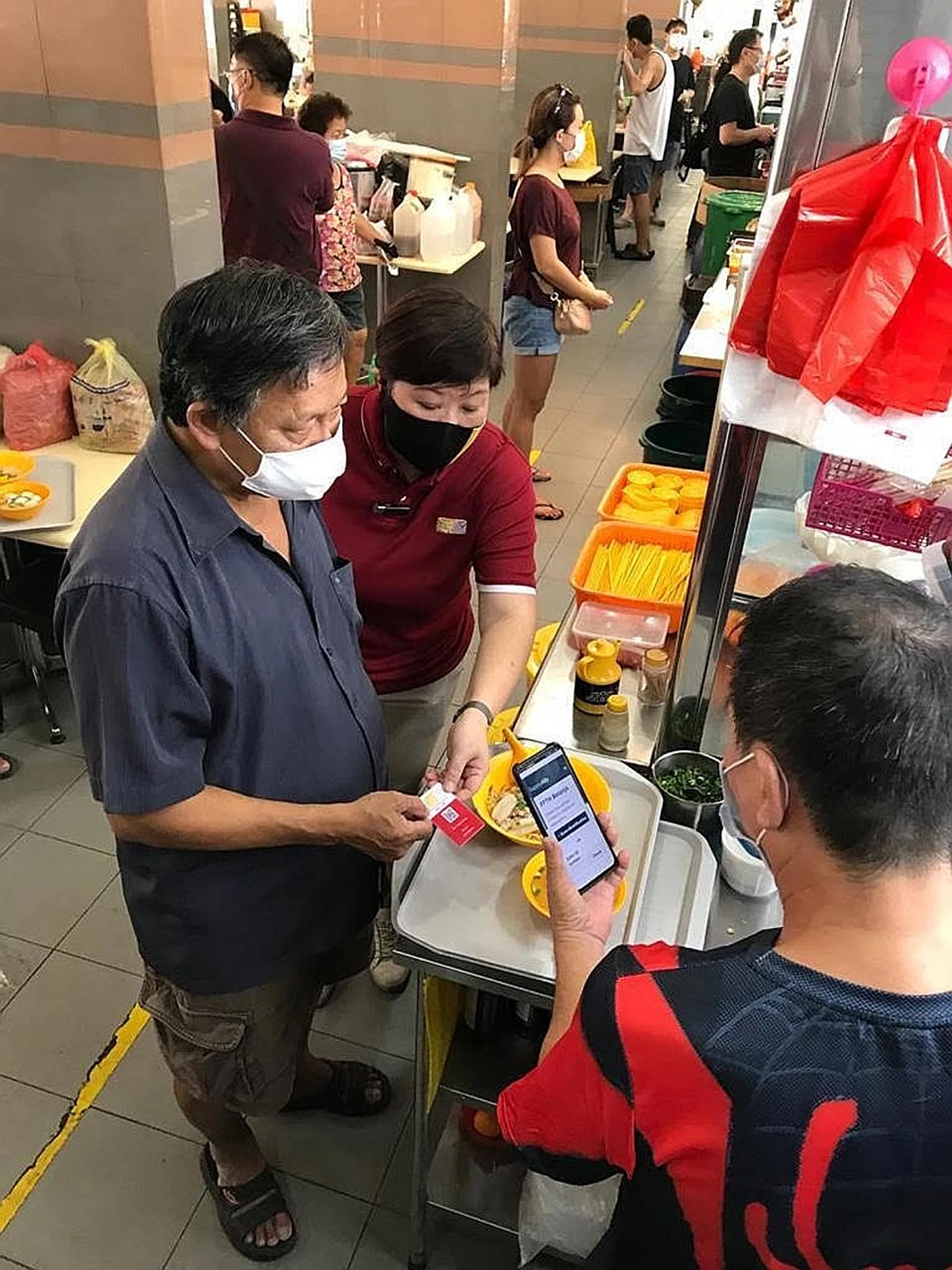 With a QR-coded beneficiary card, 104 needy residents of Mountbatten SMC can redeem hot meals at designated neighbouring eateries. 