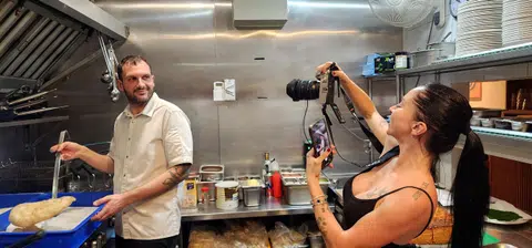 Ms Alessandra Gulino, co-owner and marketing manager of Fortuna, shooting a video of head chef Omar Tutino while he prepares a pizza.