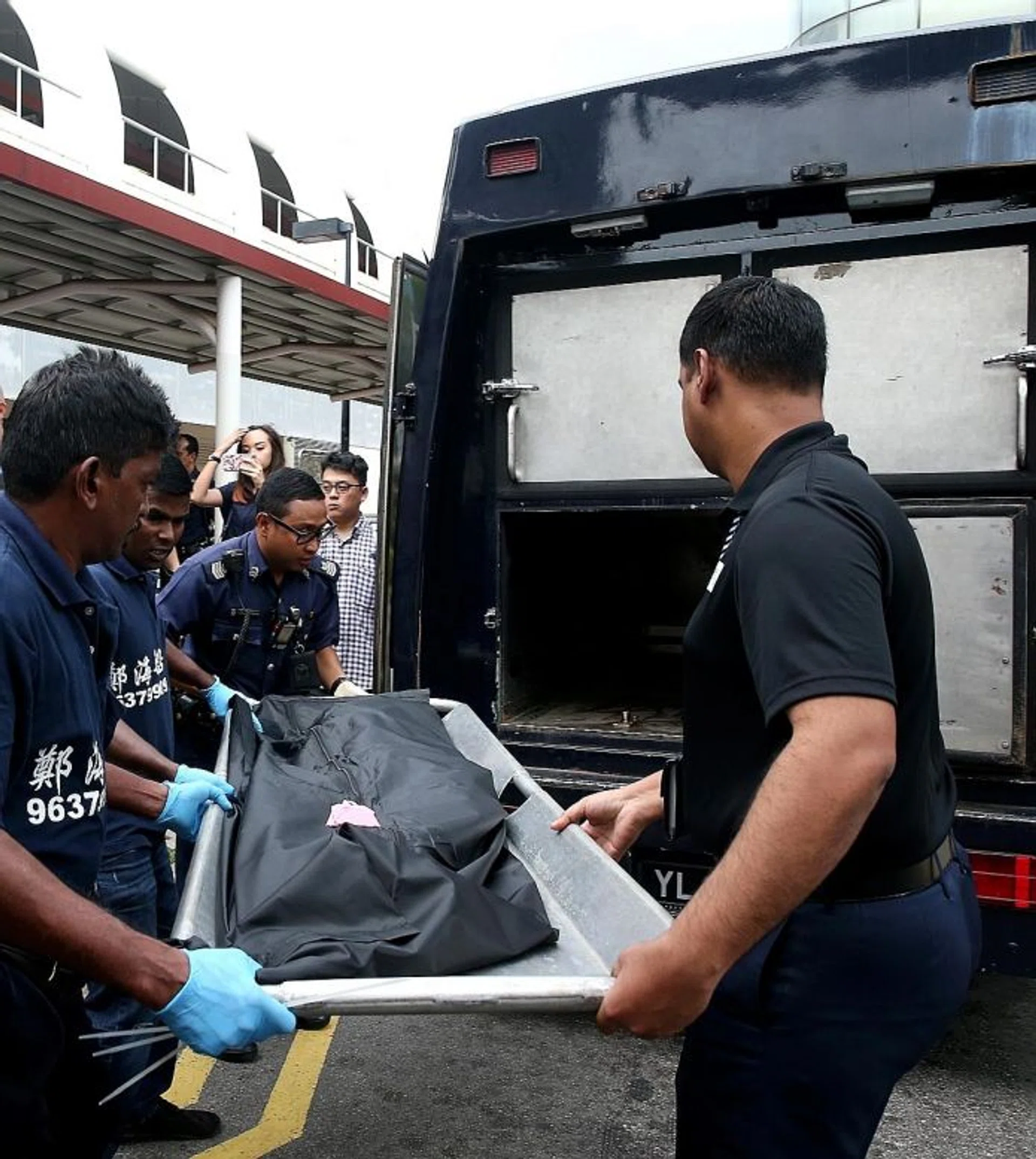 The body of the newborn, who was found in the women's toilet at Tampines MRT station, being removed.
