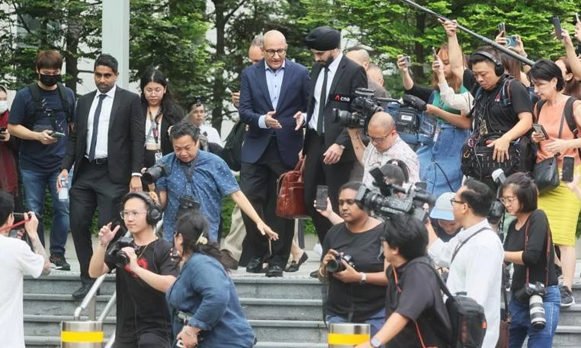 Former transport minister S. Iswaran, surrounded by the press, leaving the State Court on Jan 18.