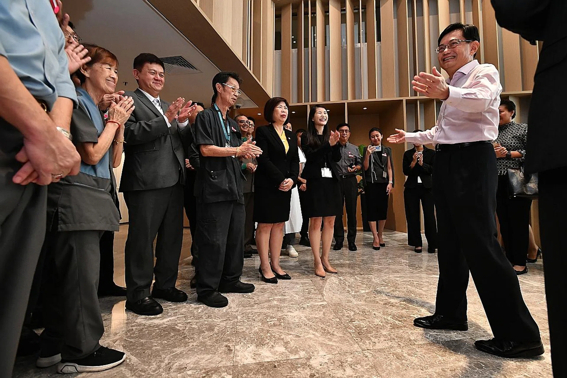 Mr Heng Swee Keat (right) speaking to Parkroyal hotel staff. 