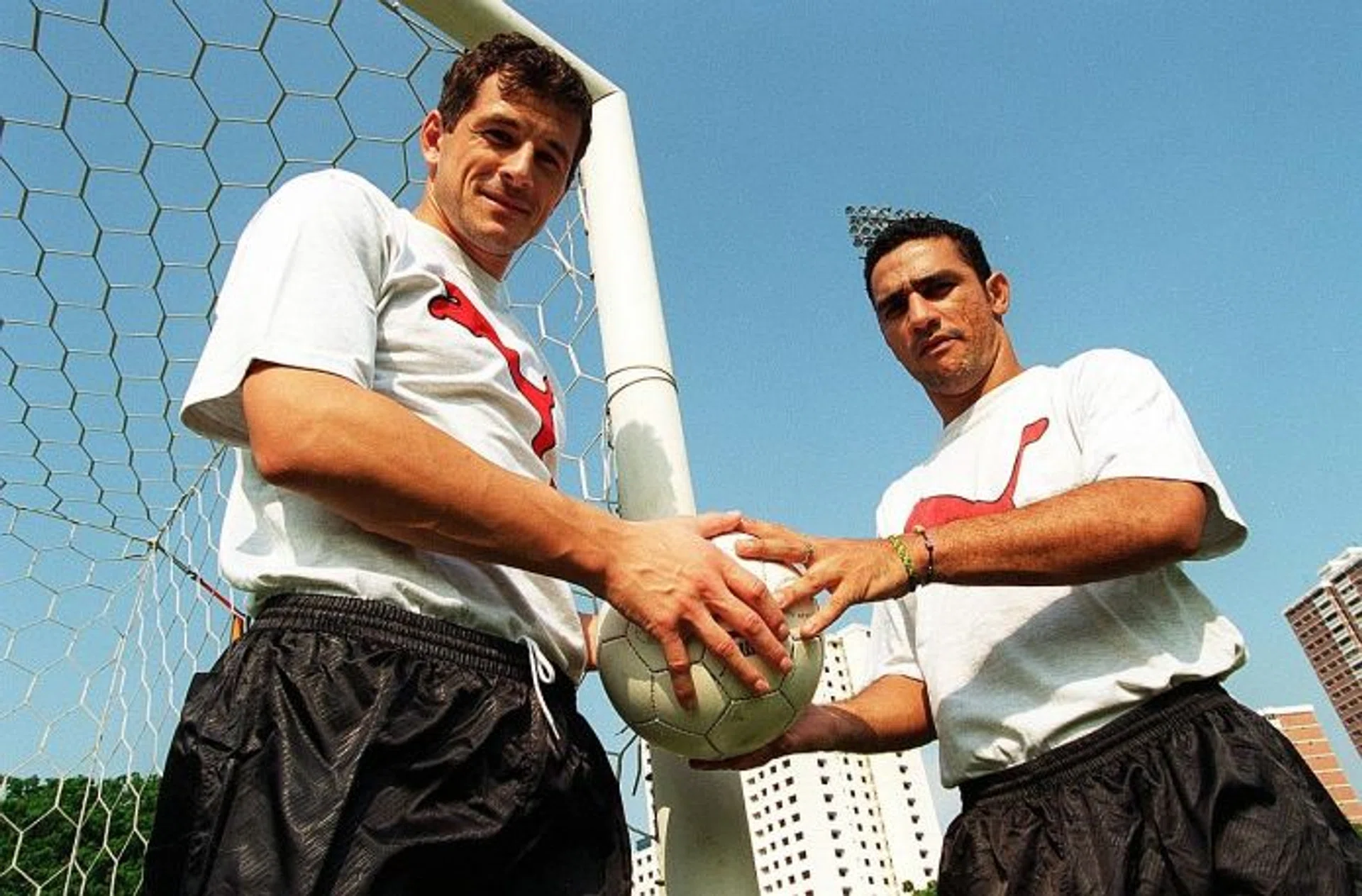 HAVING A BALL: Aleksandar Duric (left) with Tanjong Pagar teammate Fabio da Silva in 1999.