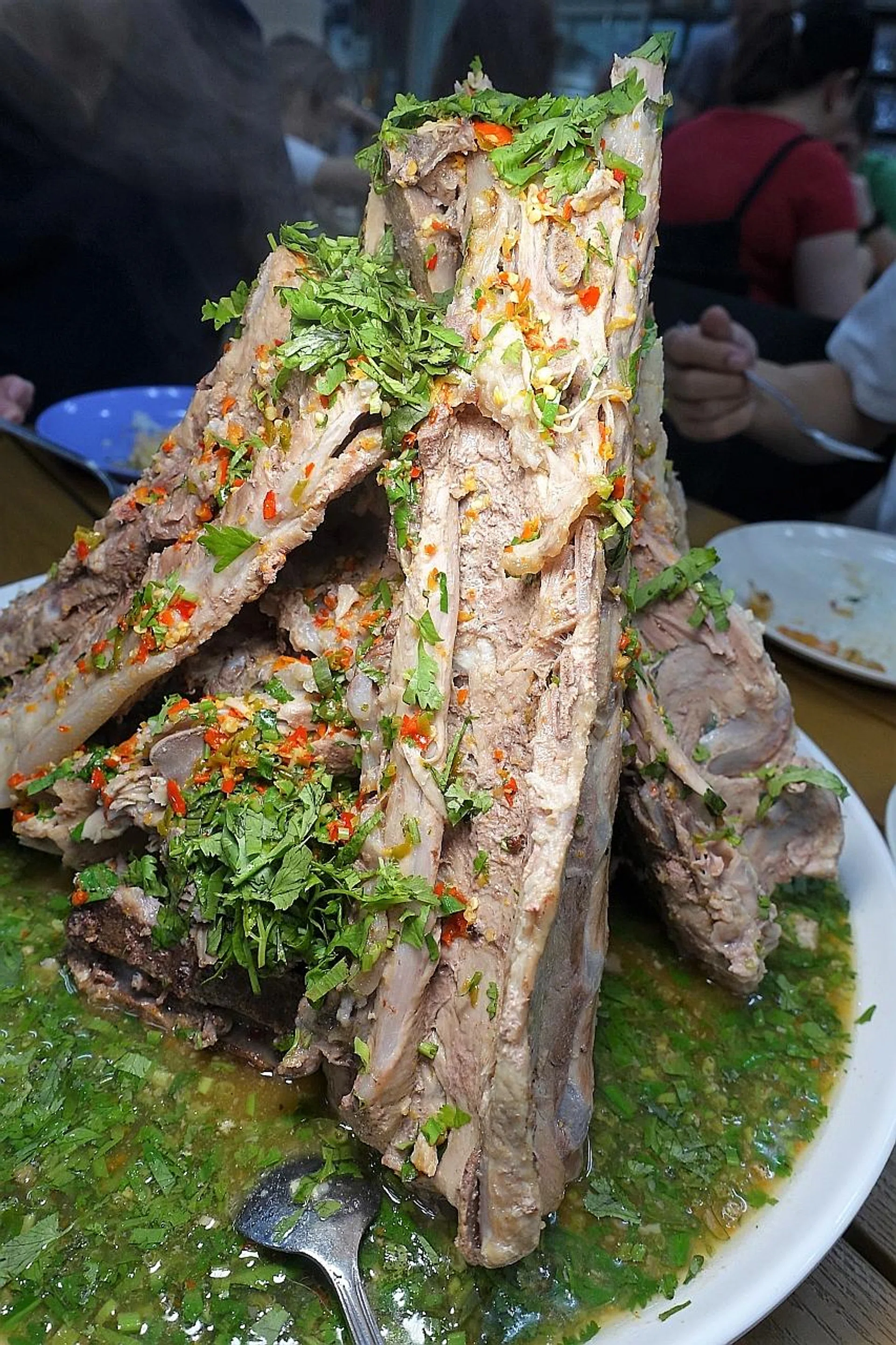 The large pork spines are stacked upright, with smaller pieces in between. 