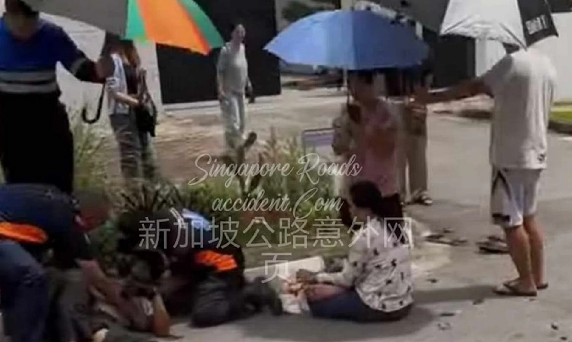 Several people can be seen sheltering and tending to the injured people. 