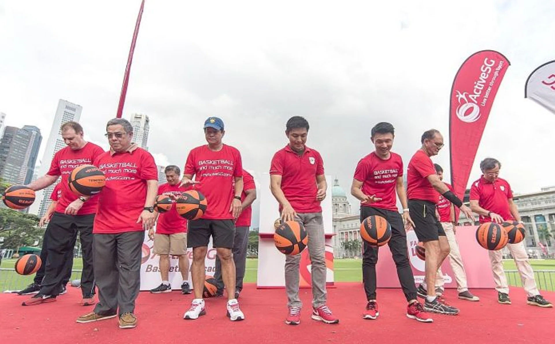 BOUNCE AWAY: Minister for Social and Family Development Tan Chuan-Jin (fourth from far left in front row) and Ministry for Culture, Community and Youth Parliamentary Secretary Baey Yam Keng (fifth from far left) leading the Singapore Book of Records attempt for the most number of people bouncing basketballs together. A total of 2,180 participants combined to break the record.