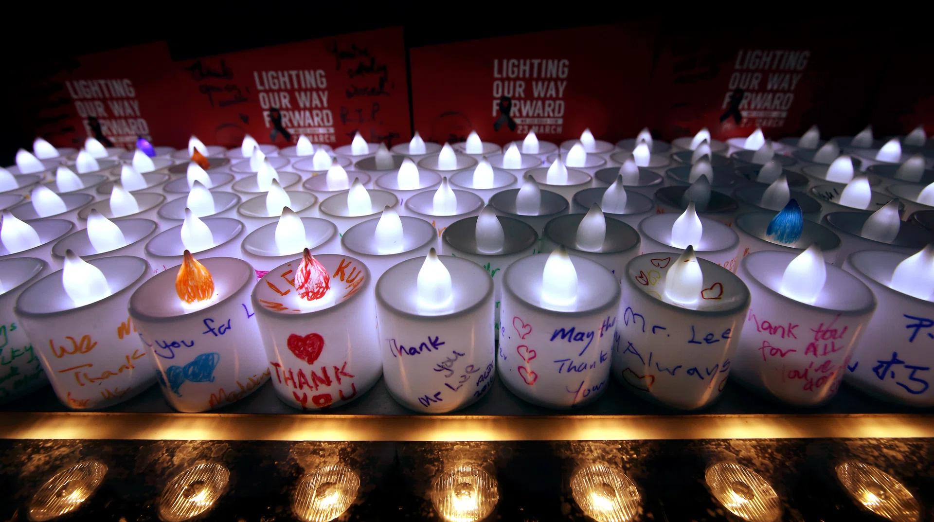 LIT UP: About 3,000 electric candles were handed out to passers-by at the Padang.