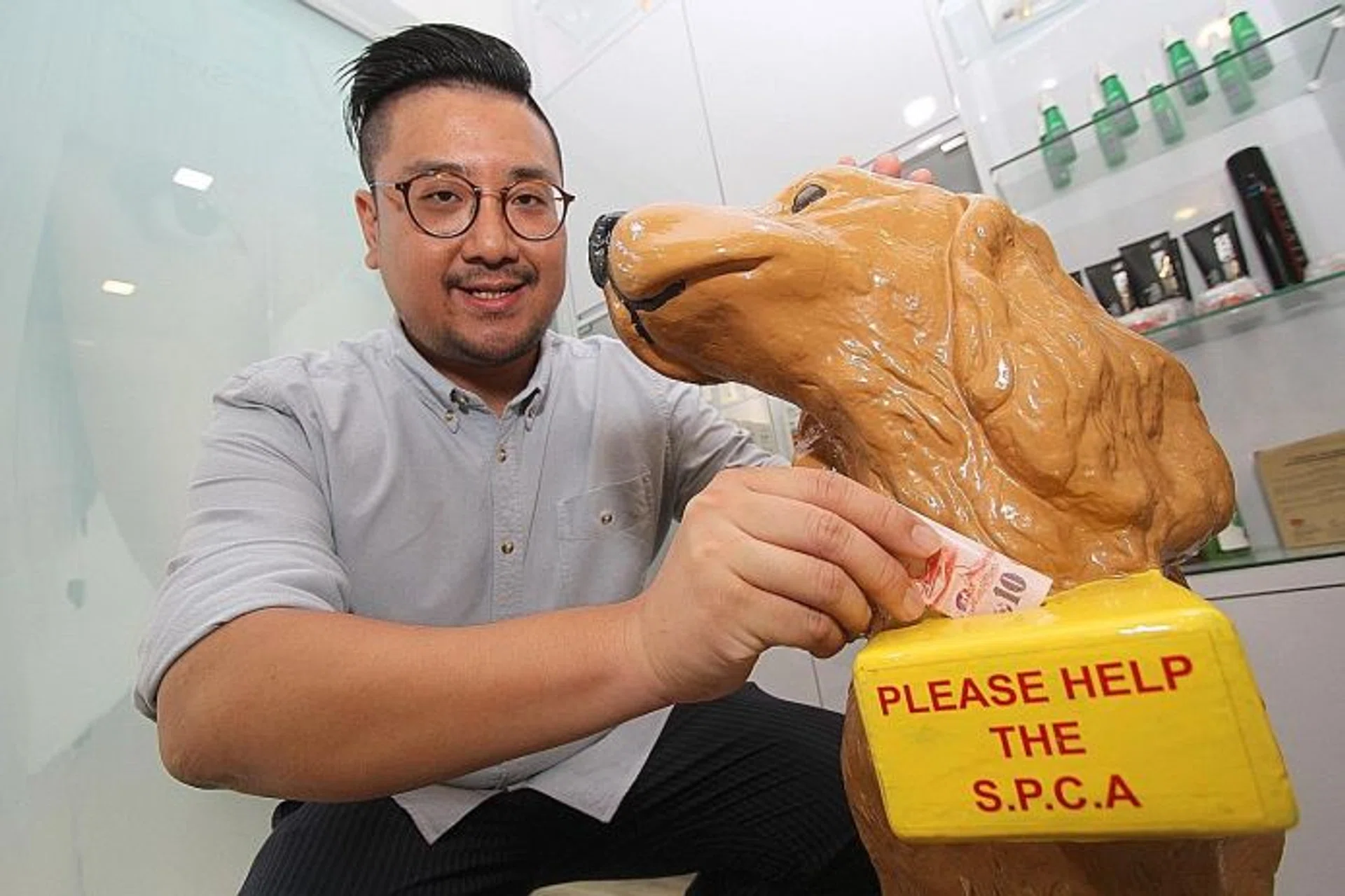 DOG LOVER: Mr Shigekawa Hidekatu, the owner of hair salon Kraftcuts, adopted two dogs from an animal shelter.