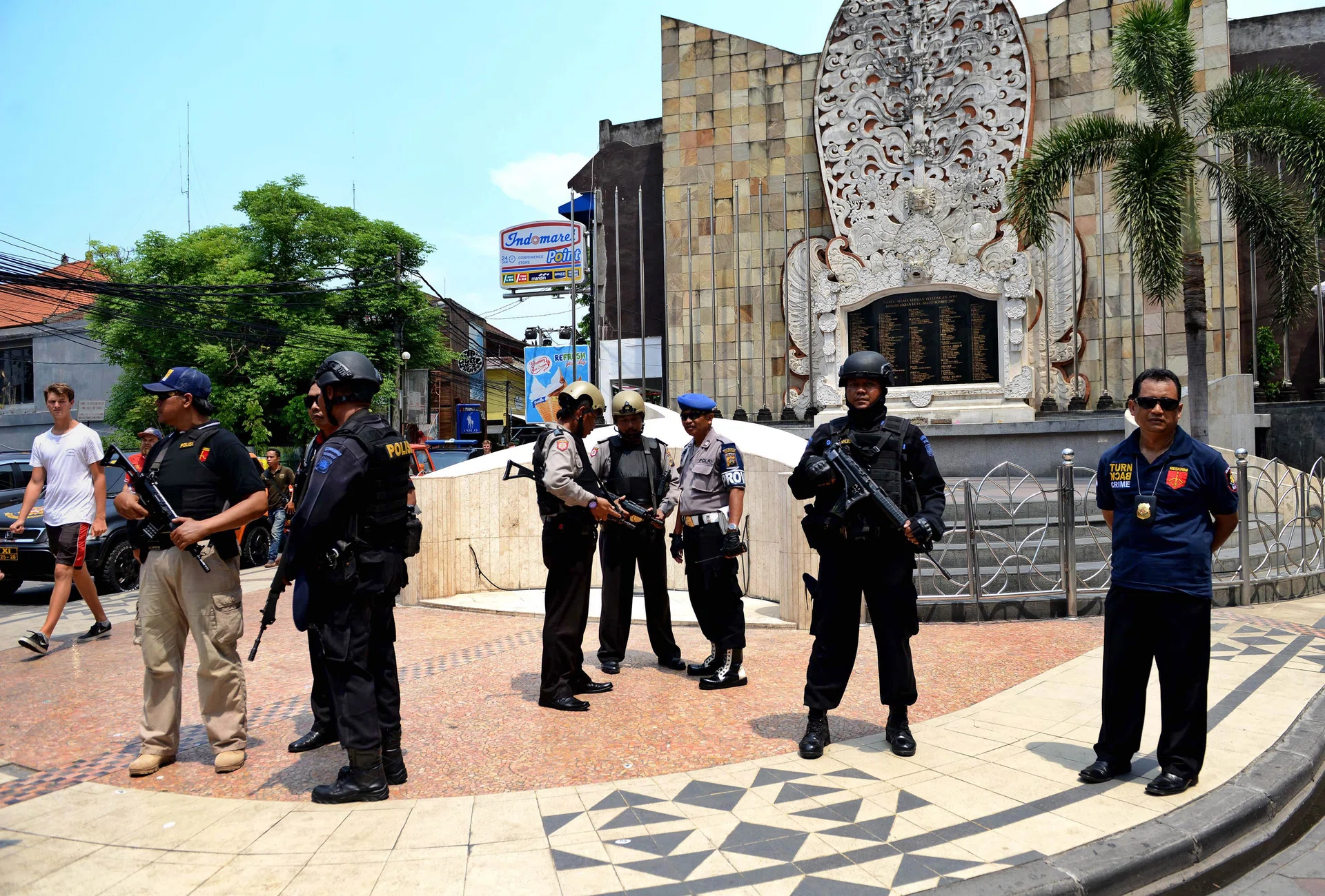 ALERT: Indonesian police standing in front of the monument dedicated to victims killed in the 2002 Bali bombing by Jemaah Islamiah, which is seeing a resurgence. 
