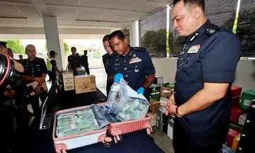 Malaysia police record statement of man who dropped off bag containing $142,000 at mall carpark