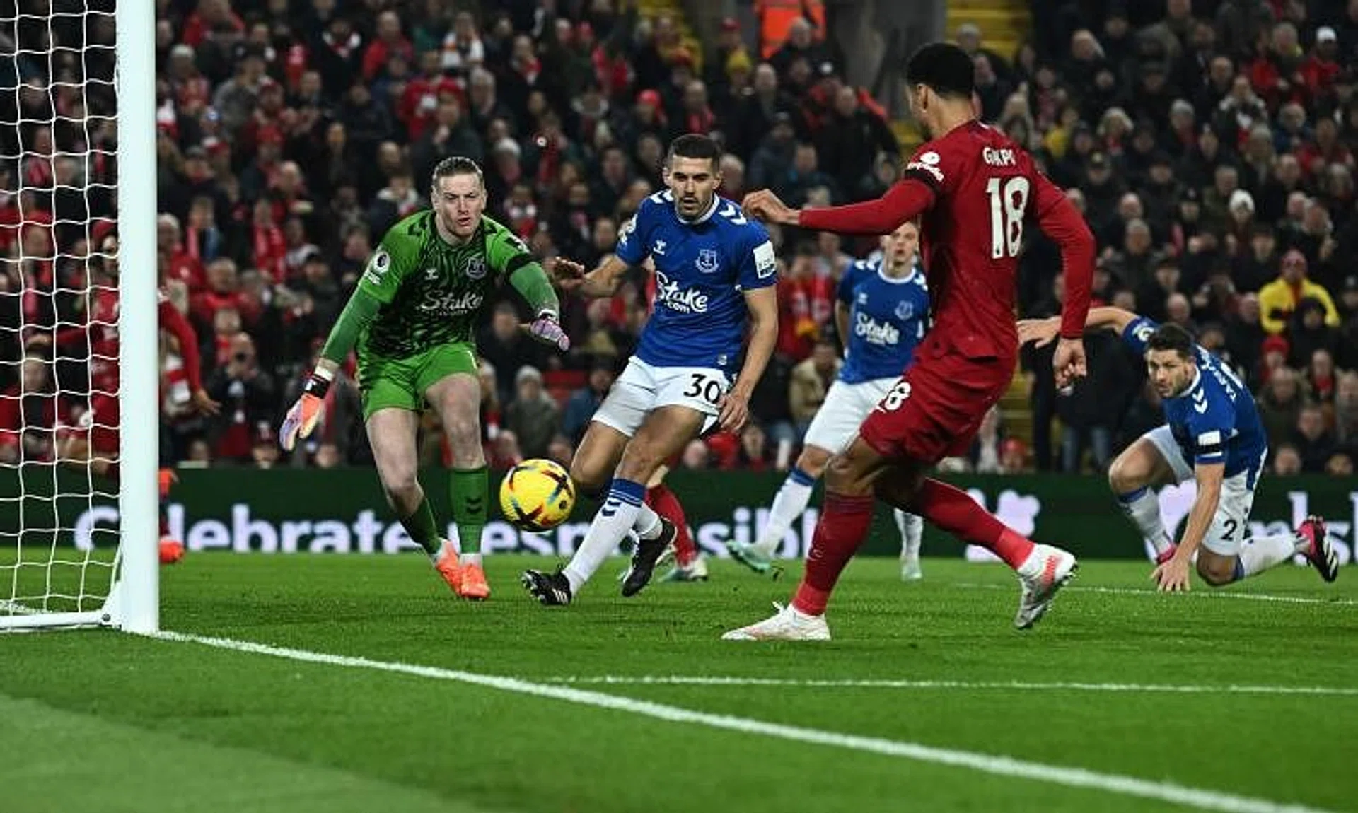 Liverpool striker Cody Gakpo scoring their second goal past Everton's Jordan Pickford en route to a 2-0 win at Anfield.