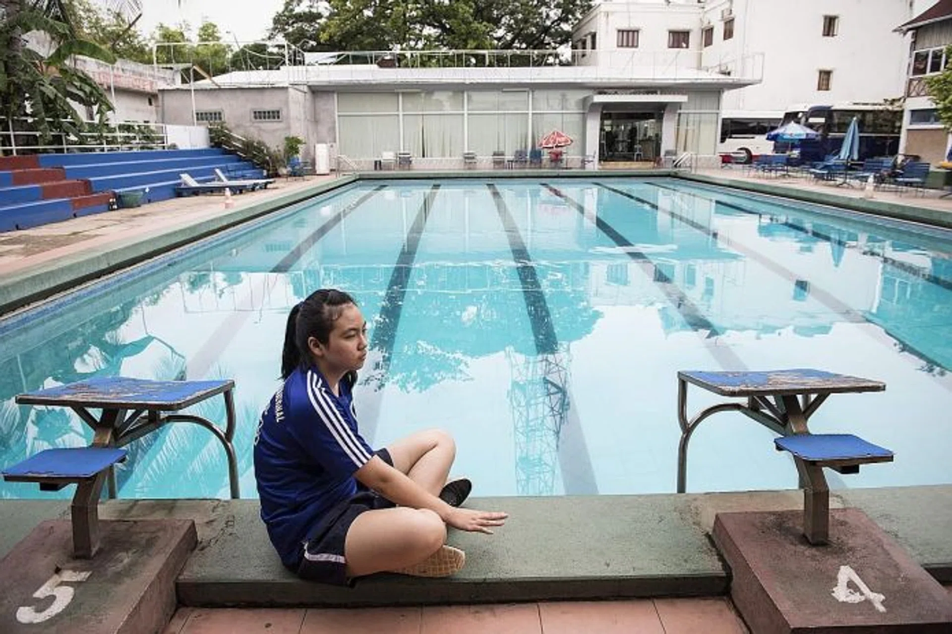 SHARED VENUE: Laos swimmer Siri Arun sitting at the Vientiane swimming pool,  a 25m public pool which she shares with other kids taking swimming lessons or who are just clowning around.