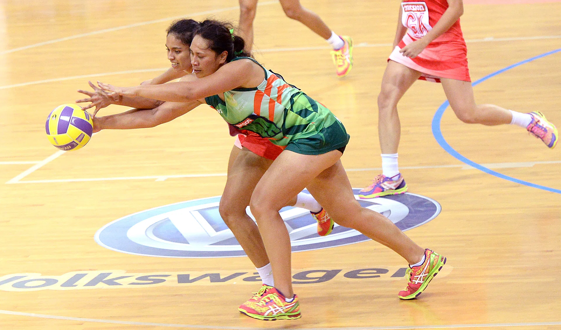 EYES FOR THE BALL: Singapore's Parveen Nair tussles with an Irish player during the Mission Foods Nations Cup opener yesterday. 