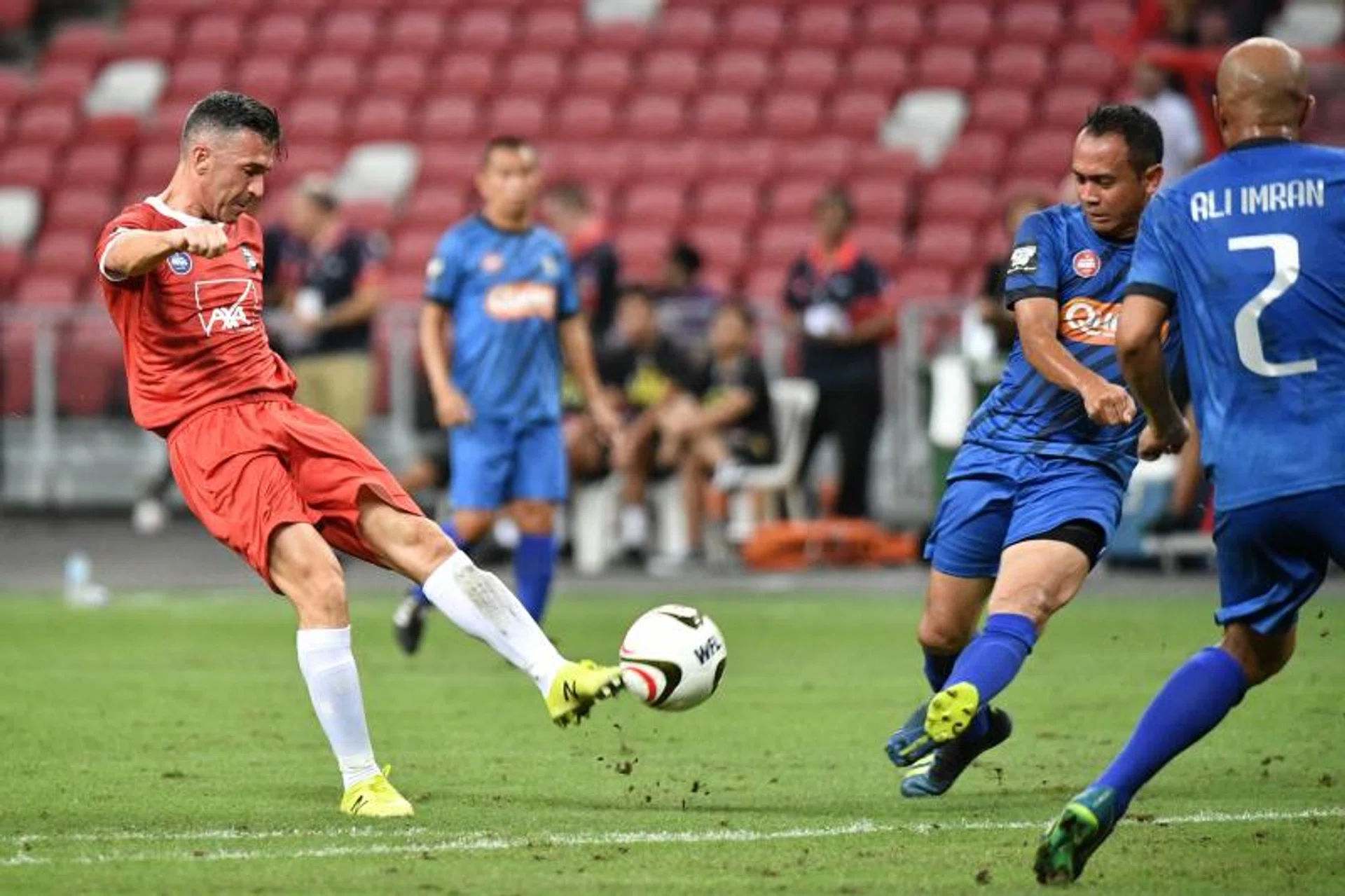 Liverpool Reds' Luis Garcia attempting a shot against the Singapore Reds.