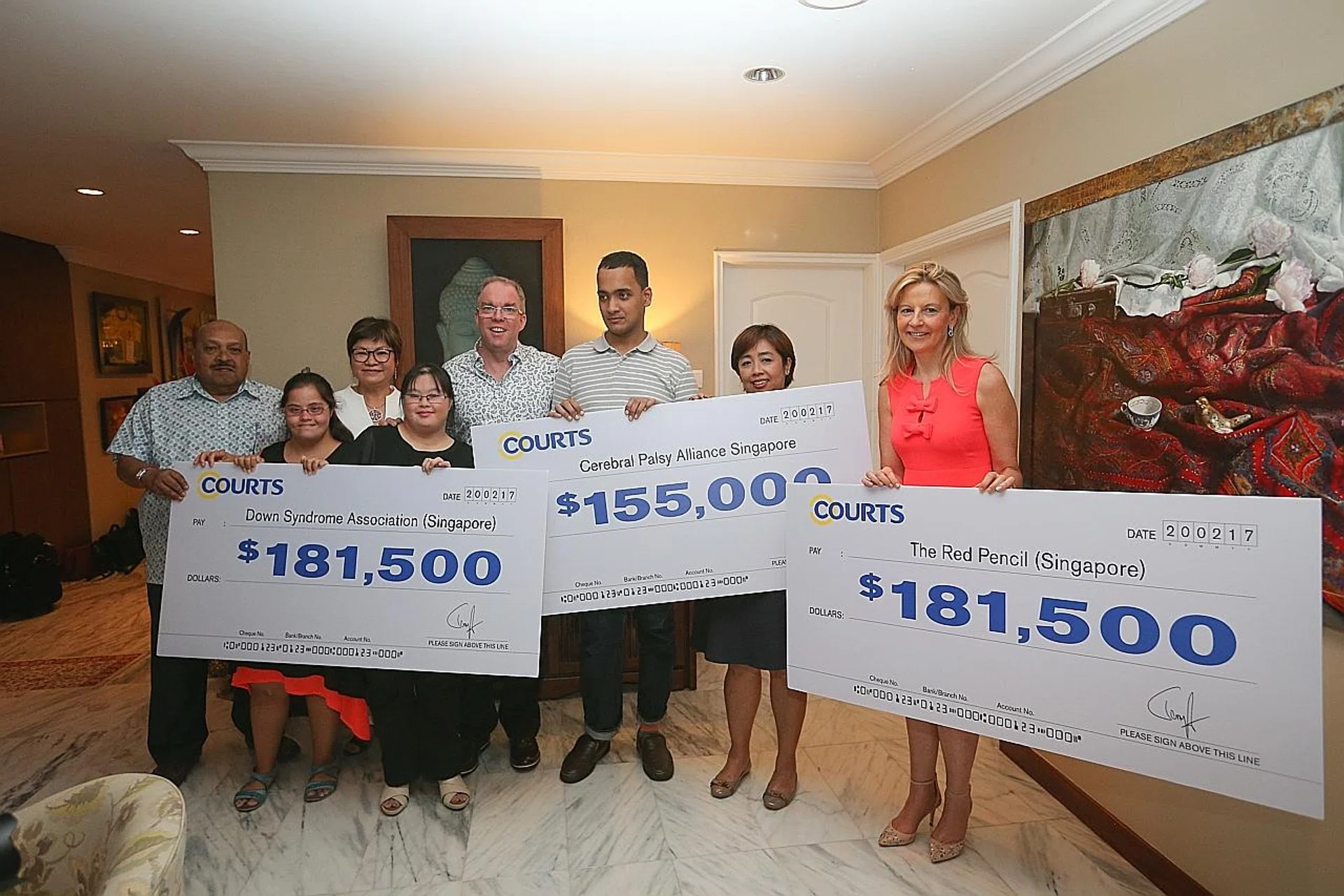 Mr Terry O'Connor, Group CEO of Courts Asia, and his wife Janice, presenting the $518,000 raised to beneficiaries from the Down Syndrome Association Singapore, Cerebral Palsy Alliance Singapore and The Red Pencil (Singapore).