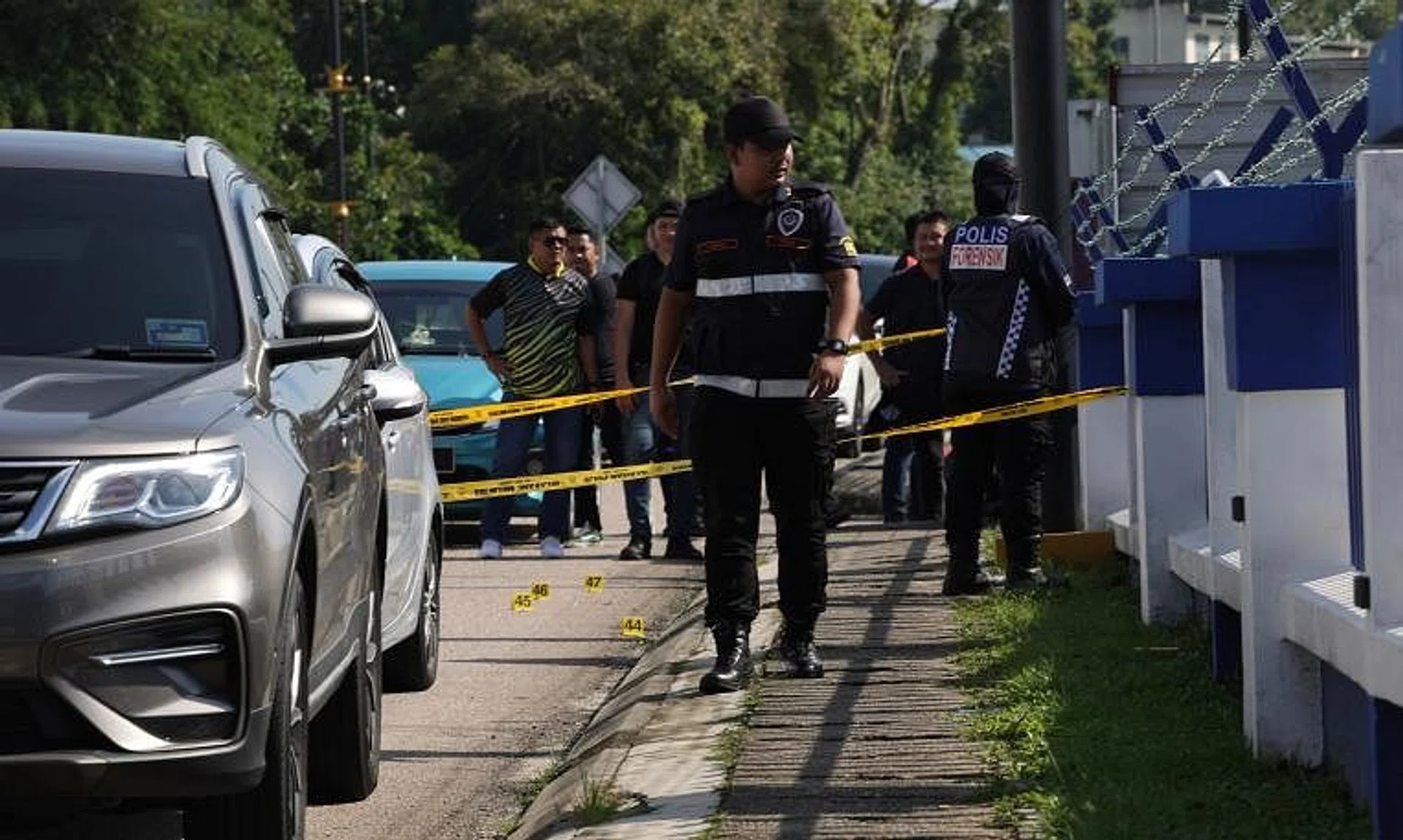 Forensic police officers at the scene of the attack at Ulu Tiram Police Station on May 17.