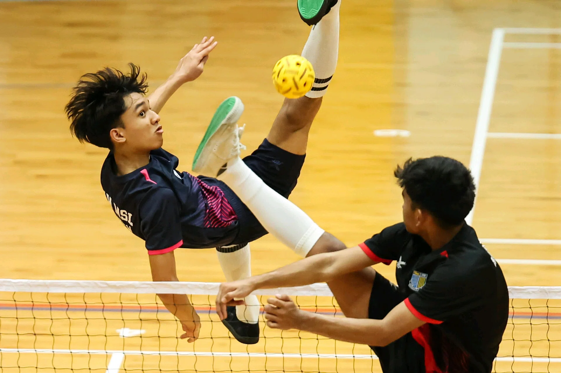 Marsiling Secondary School's Muhammad Herzy Khaliff (left) leading his team to victory in the 2025 National School Games B Division sepak takraw final on March 10.
