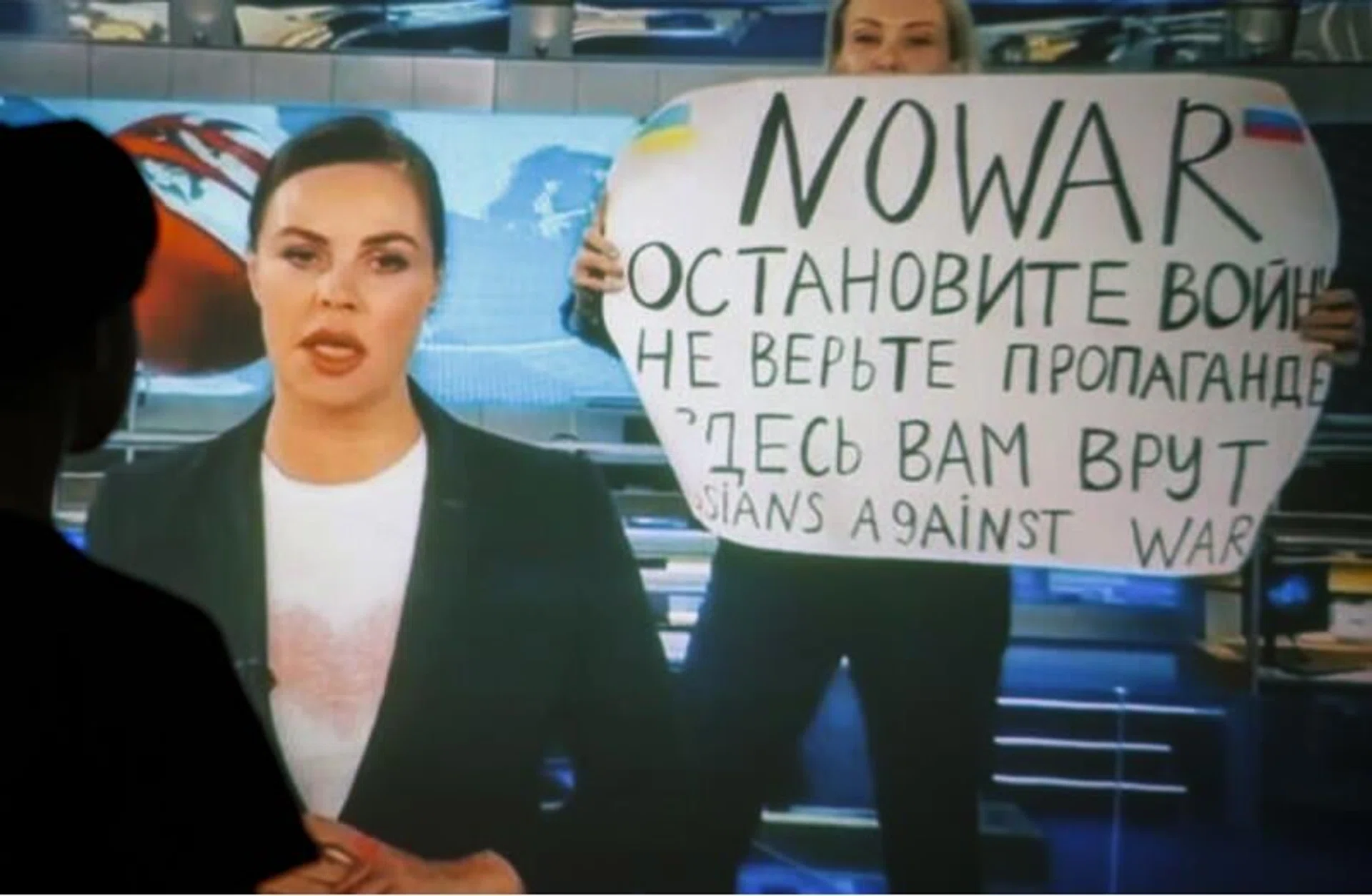 A woman watches a recorded feed of the Russian Channel One March 14 news broadcast during which Ms Marina Ovsyannikova, who worked as an editor, held up the No War poster with this message in Russian: "Stop the war. Don't believe the propaganda. You are being lied to here".