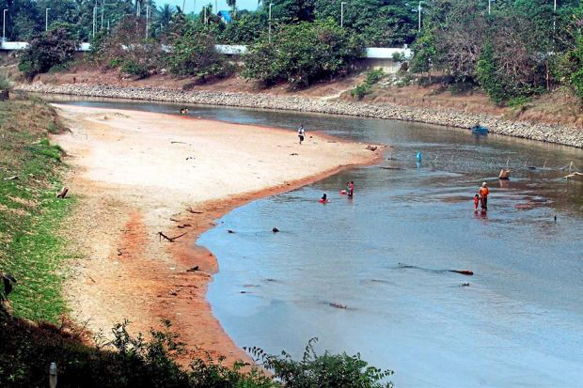 HEATWAVE: (Above) A dried-up Sungai Golok, a dam in Johor with dropping water levels and water rationing taking place. 