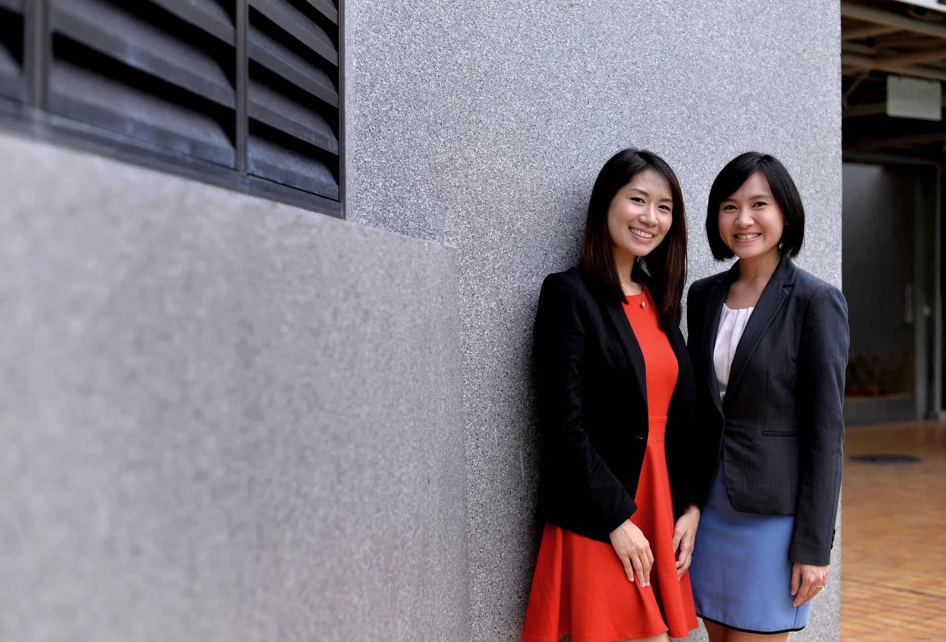 HELPING HANDS: Gambling safeguards officer Lee Xinyi (in red) and child protection officer Applie Wan are in their jobs to make a difference. 