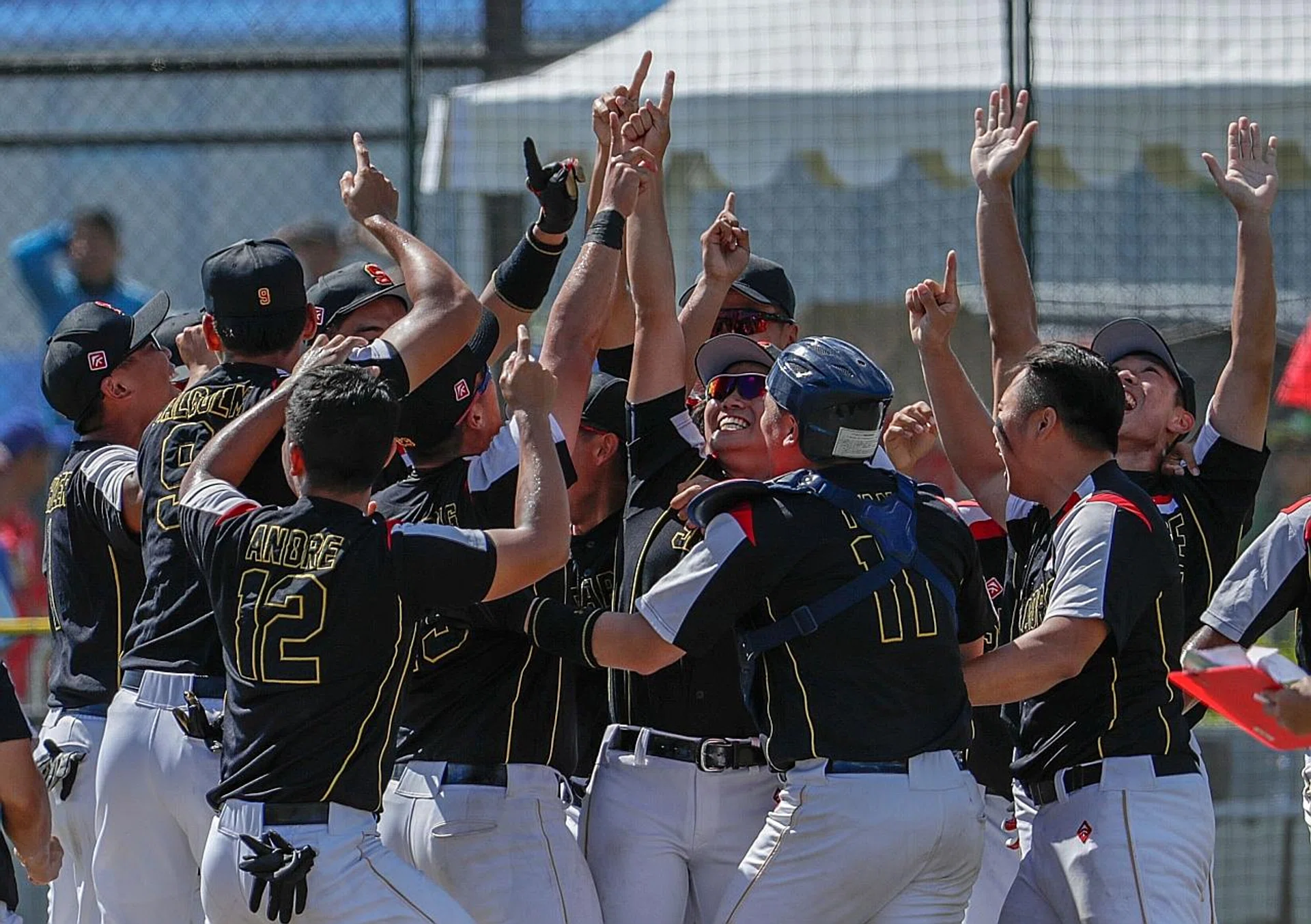 The Singapore men's softball team celebrating their historic victory over hosts Philippines yesterday.  