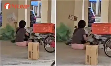 Woman sits in Tampines void deck, sorts parcels by tossing them around