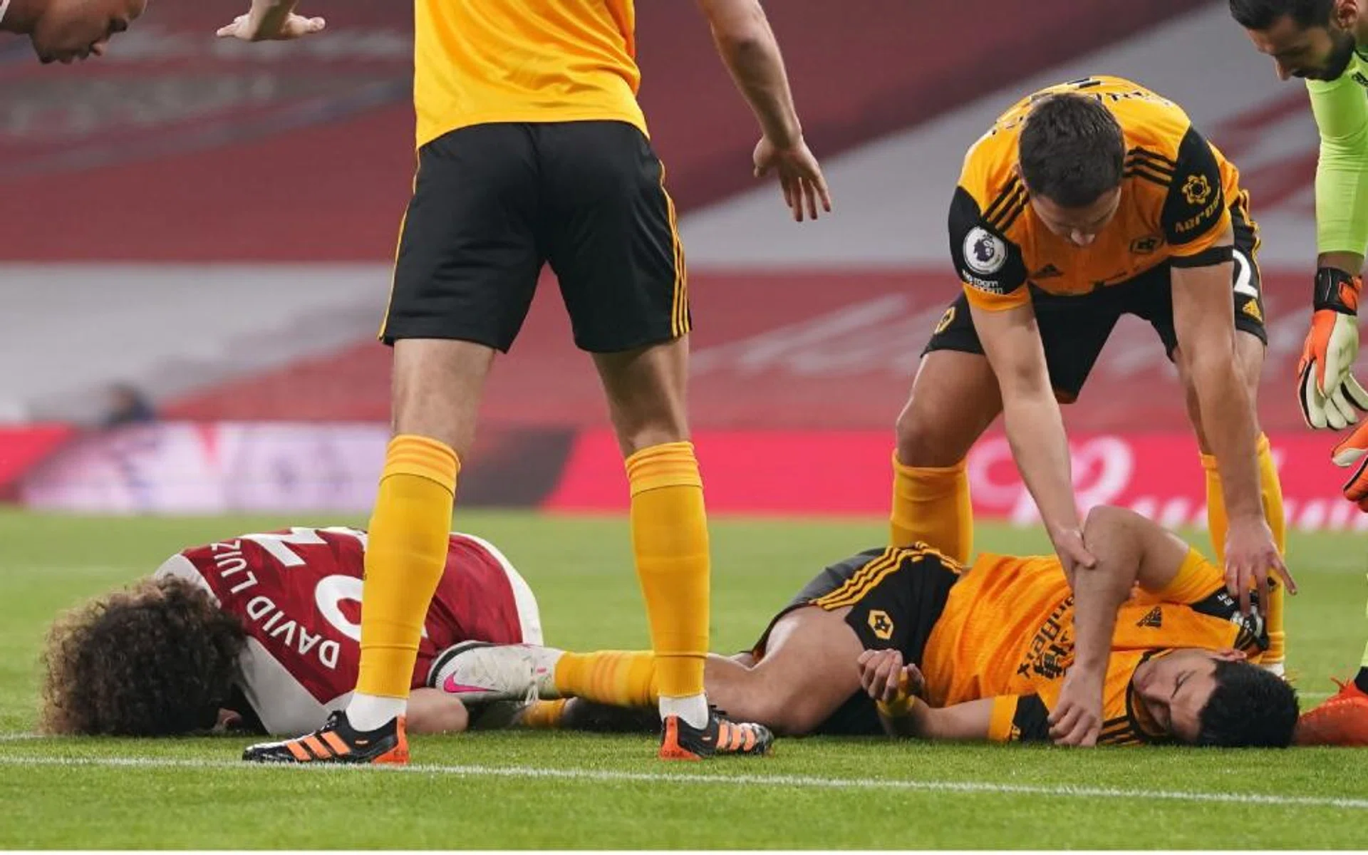 Arsenal defender David Luiz and Wolverhampton Wanderers striker Raul Jimenez (in orange) on the ground after a head-on collision in an EPL game last month.