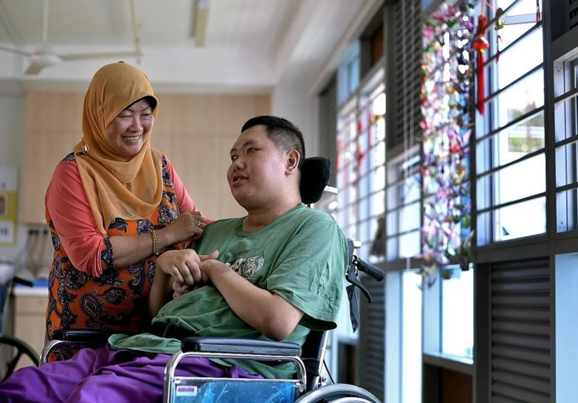 CARE: Madam Jamilah Othman's son Mr Khairul Abdul Majid is in a nursing home after getting into an accident 12 years ago.