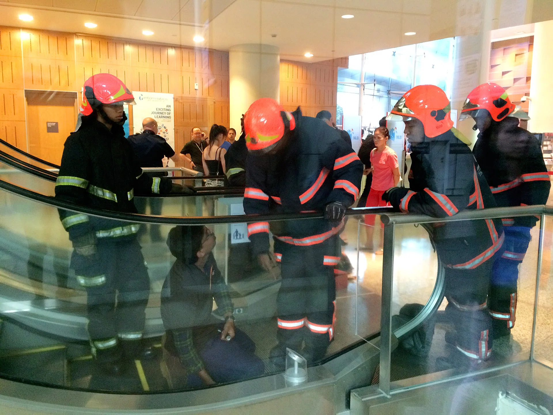 AFTERMATH: Singapore Civil Defence Force officers trying to retrieve the boy’s shoe.