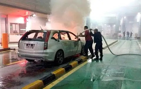 Car on fire at JB Customs
