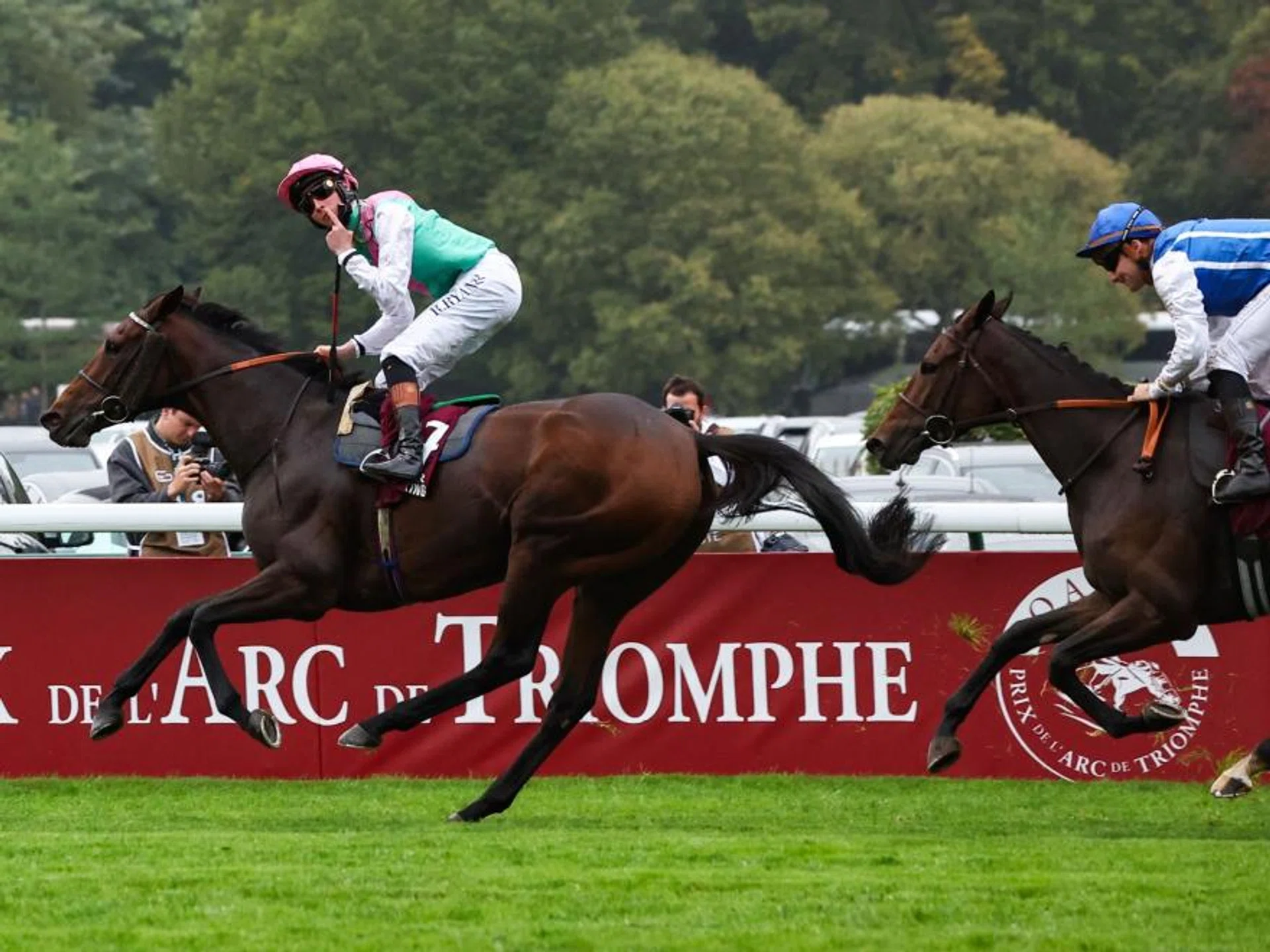 Irish jockey Rossa Ryan saluting the crowd after the Ralph Beckett-trained English mare Bluestocking races away from Aventure (Stephane Pasquier) to spring a mild surprise with her win in the 2024 Group 1 Qatar Prix de l'Arc de Triomphe (2,400m) at Longchamp on Oct 6. It was a seventh Arc for the Juddmonte Farms.
