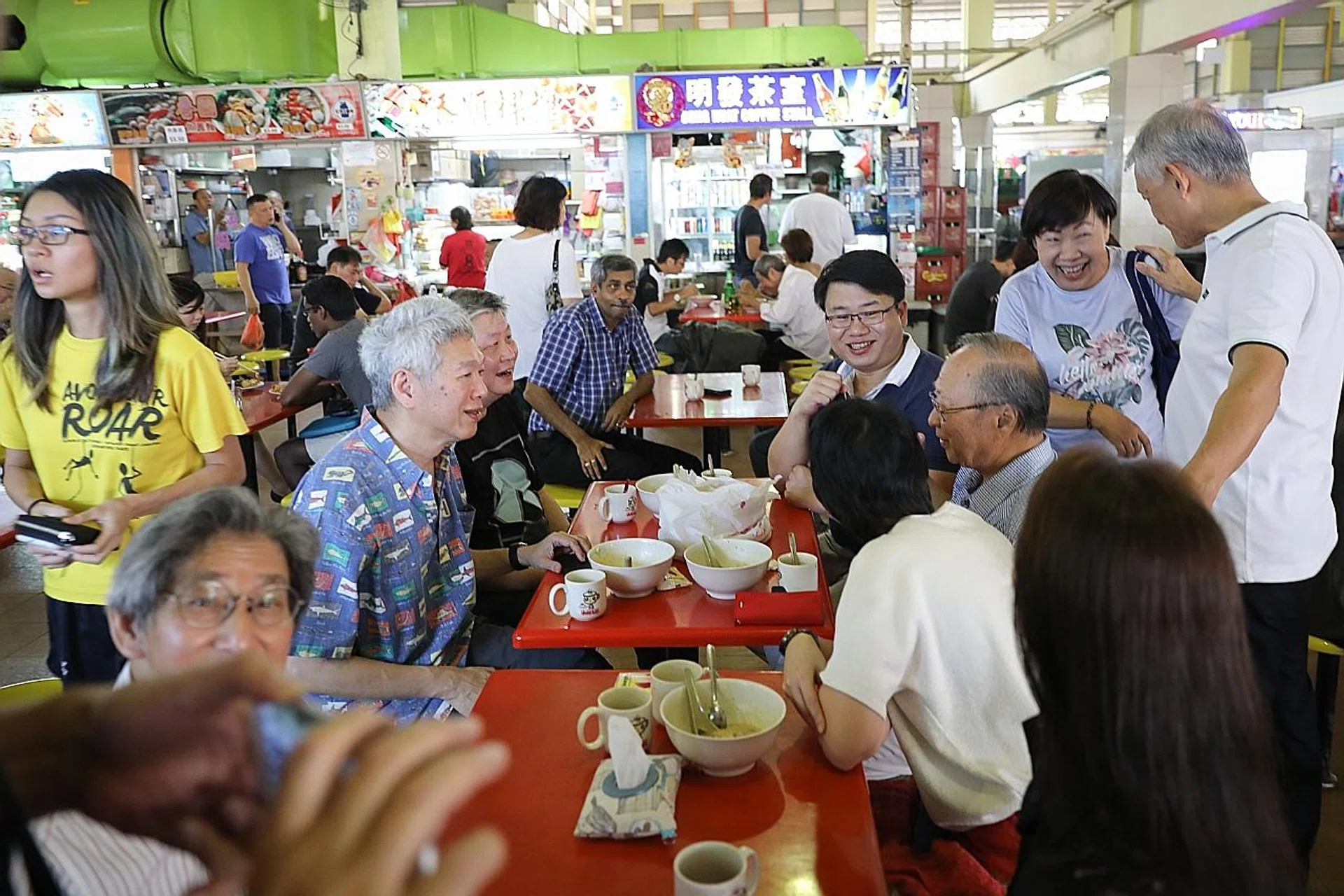 Mr Lee Hsien Yang (left) and Dr Tan Cheng Bock (far right) were spotted having porridge and coffee with dough fritters for breakfast at West Coast Market and Food Centre yesterday. 