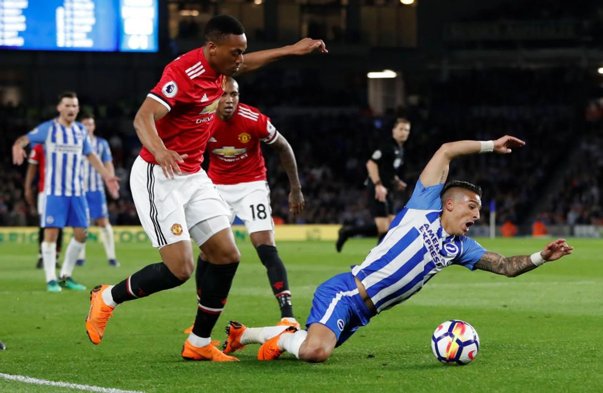 Brighton's Anthony Knockaert goes down in the penalty area after a challenge from Manchester United's Anthony Martial.