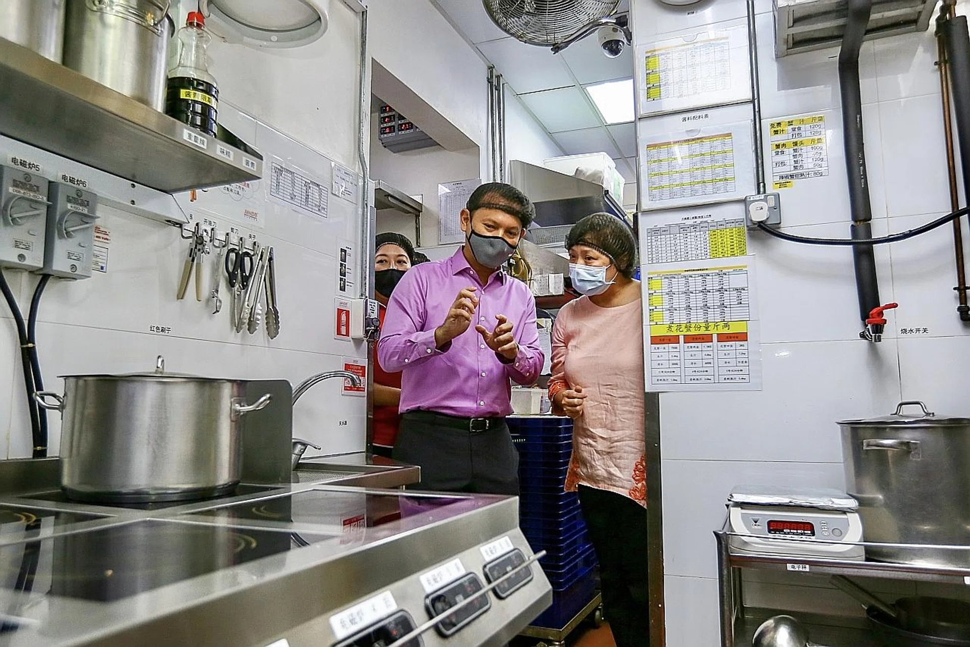 Senior Minister of State for Manpower Zaqy Mohamad during his visit to Jumbo Seafood restaurant yesterday. He said the Tripartite Workgroup on Lower-Wage Workers is exploring ways to improve the well-being of such workers. 