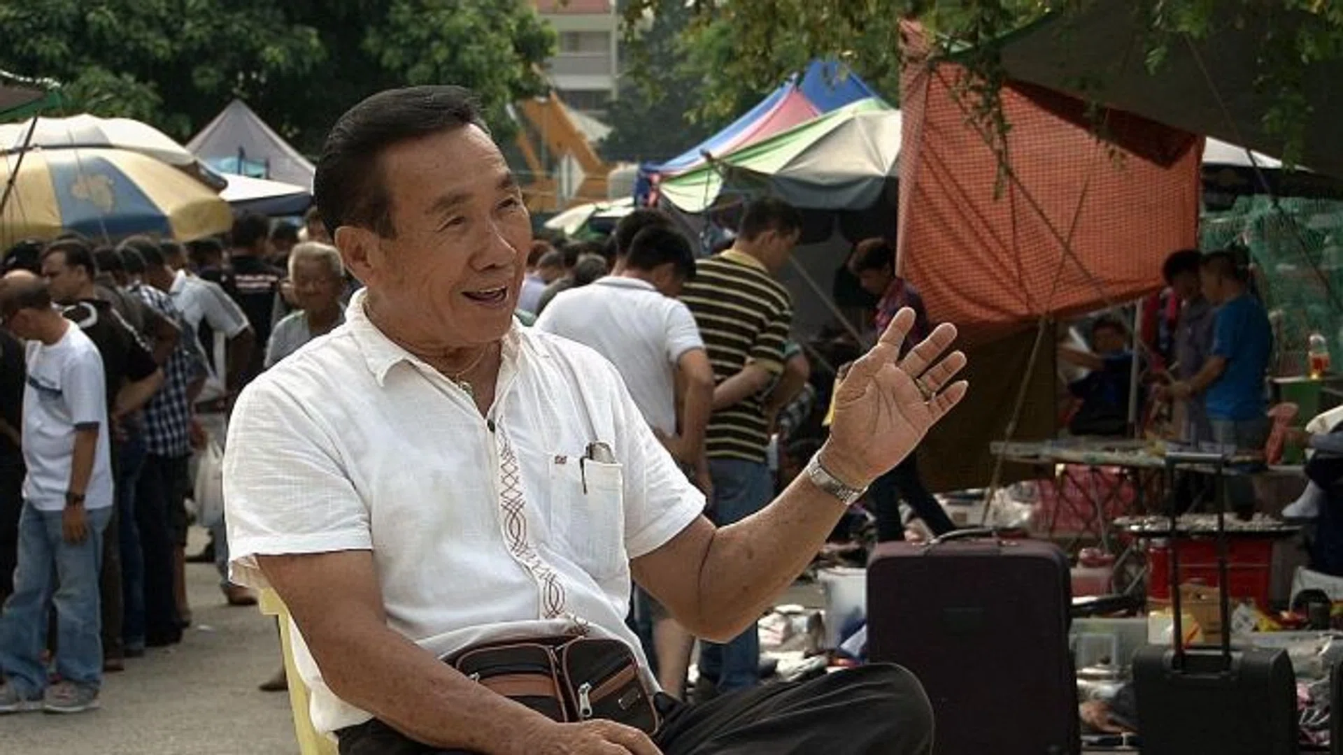 OLD IS GOLD: Mr Koh Eng Khoon sharing his story as a street peddler at Sungei Road.