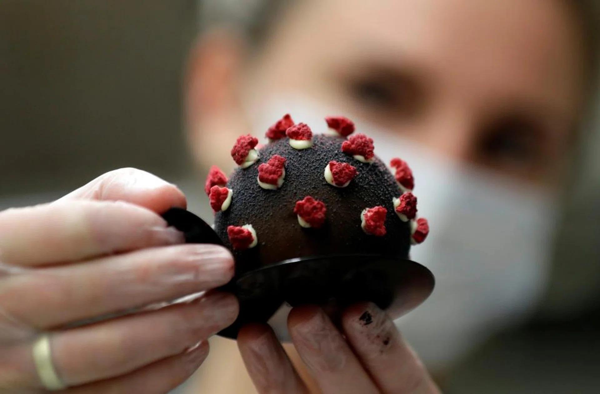 A confectioner arranges a cake shaped like a microscopic view of the coronavirus SARS-CoV-2 at a bakery, amid concerns about the spread of the disease (COVID-19), in Prague, Czech Republic, October 6, 2020. 