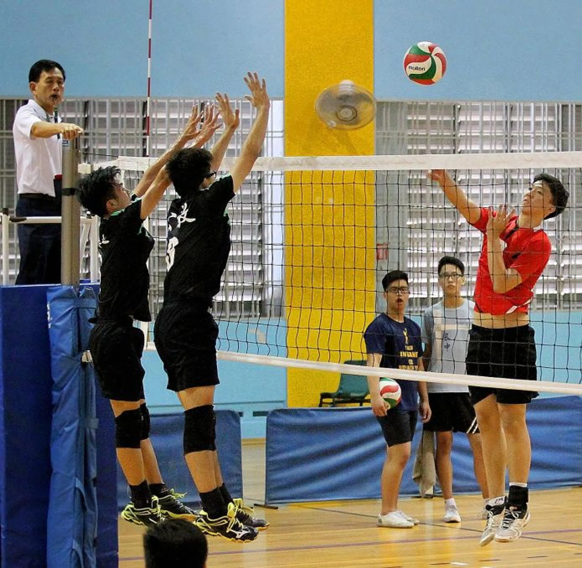 ATTACK: Presbyterian High captain Wngta Ang (in red) in action at yesterday's game.   