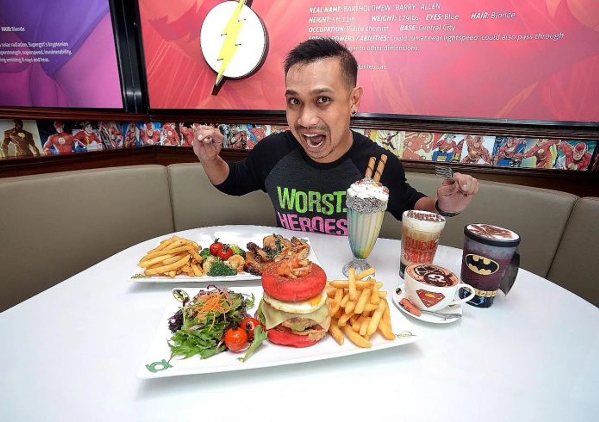 ATTACK! ONE FM 91.3 radio DJ Elliott Danker gets ready to try the food at DC Comics Super Heroes Cafe at The Shoppes at Marina Bay Sands.