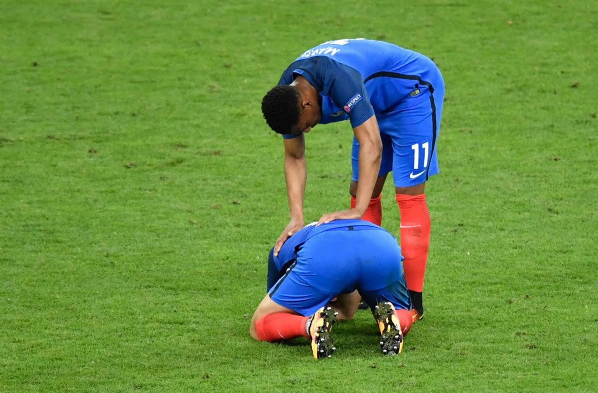 Anthony Martial consoles Andre-Pierre Gignac after France's defeat to Portugal in the Euro 2016 final.