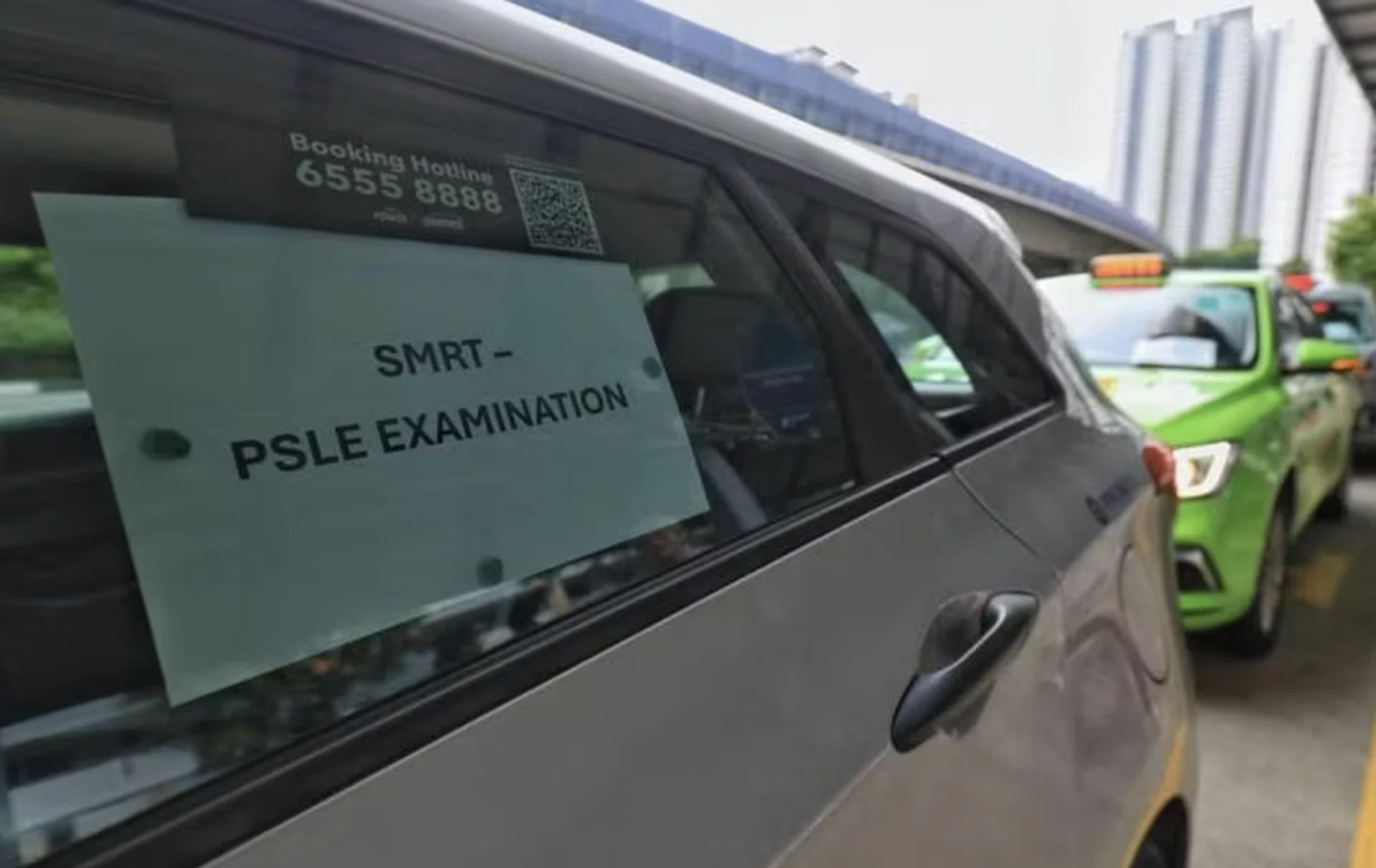 Taxis waiting to ferry PSLE candidates to exam venues.