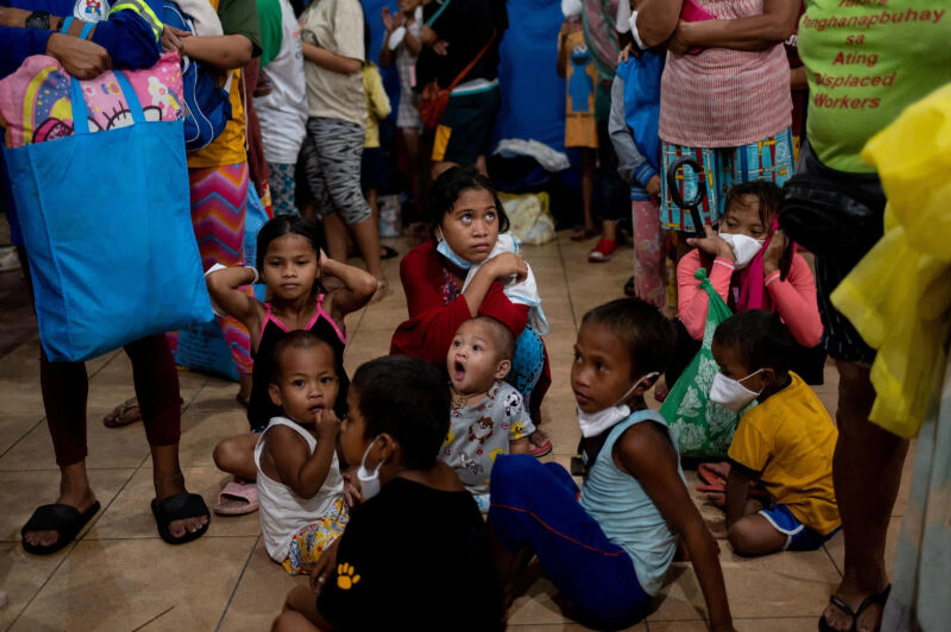 Children take shelter at an evacuation center, in preparation for Super Typhoon Noru, in Manila, Philippines.
