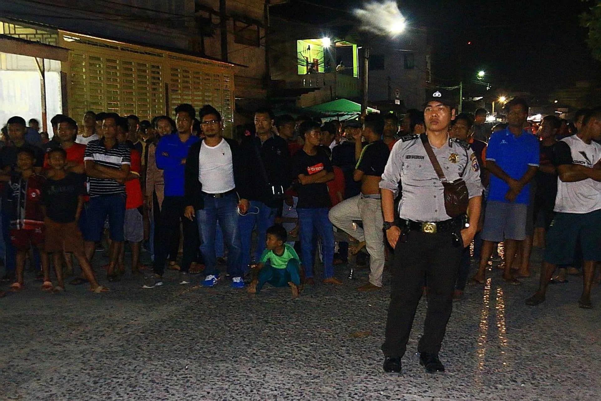 A police officer standing guard following an explosion after police arrested a suspected terrorist in Sibolga, North Sumatra province, Indonesia. 