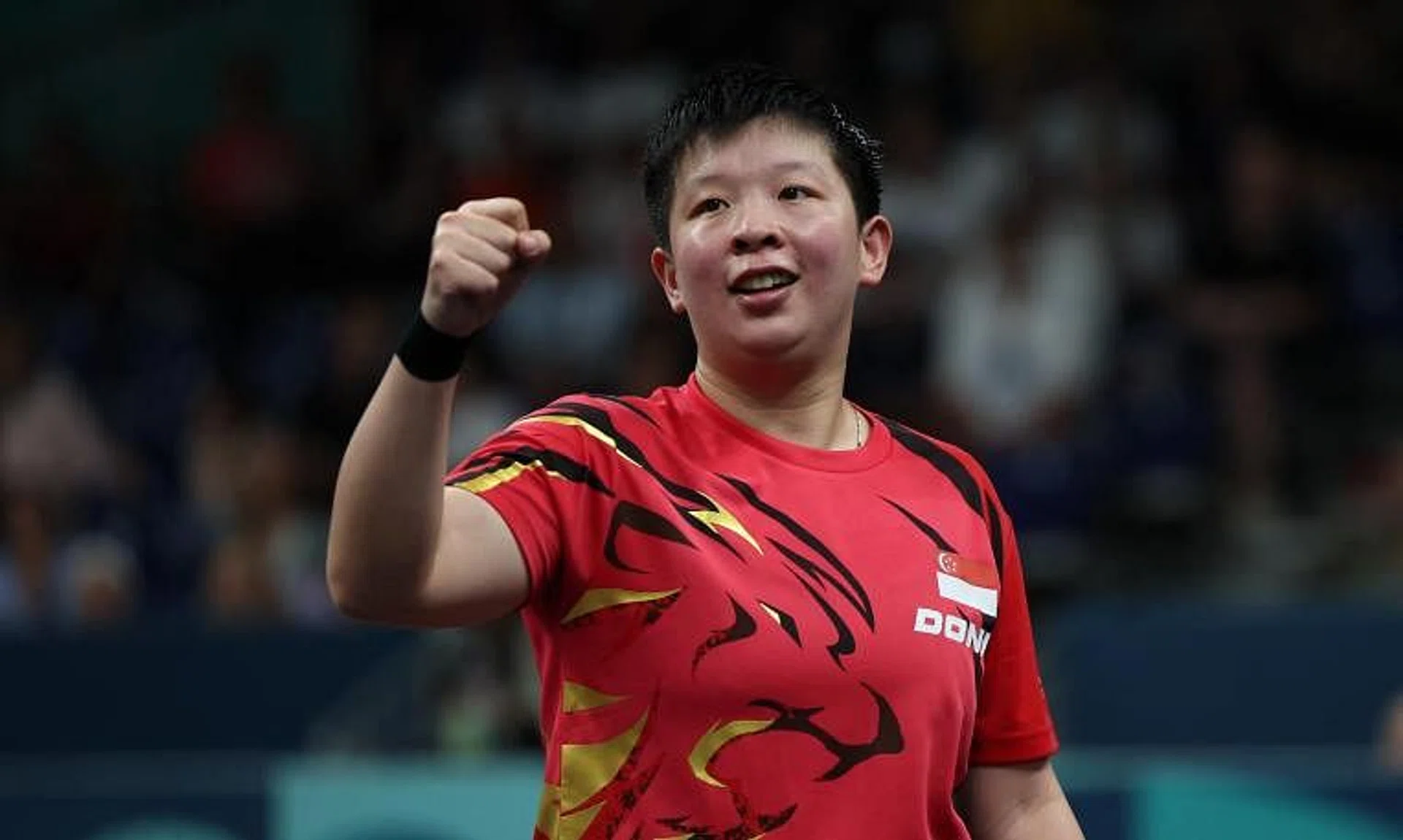 Singapore's Zeng Jian celebrated after winning her round of 64 match against Ivana Malobabic of Croatia.